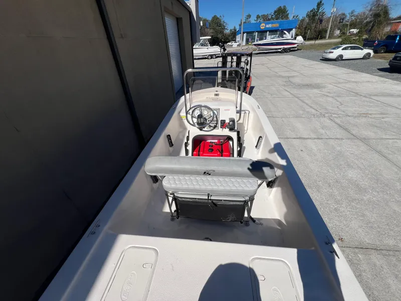 Slide: The Image of 2025 Carolina Skiff E 16 JVX boat, white interior, parked outdoors. - 5