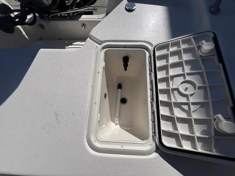 Slide: The Image of 2025 Carolina Skiff E 16 JVX boat storage compartment with open lid. - 7