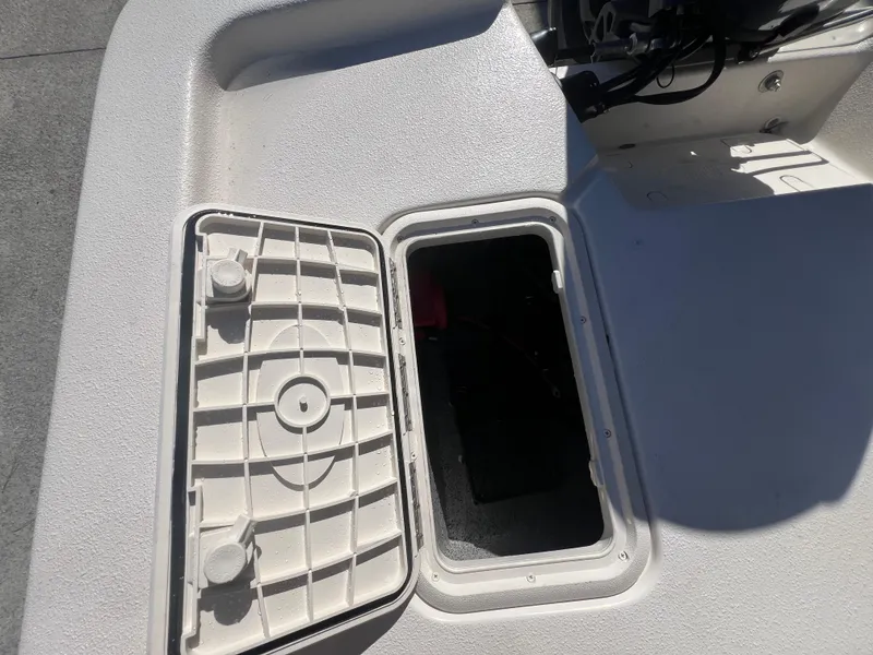 Slide: The Image of Open storage compartment on 2025 Carolina Skiff E 16 JVX boat. - 8