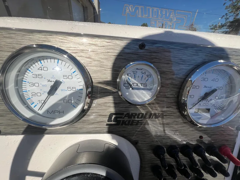 Slide: The Image of Dashboard of 2025 Carolina Skiff E 16 JVX with speedometer and voltmeter gauges. - 9