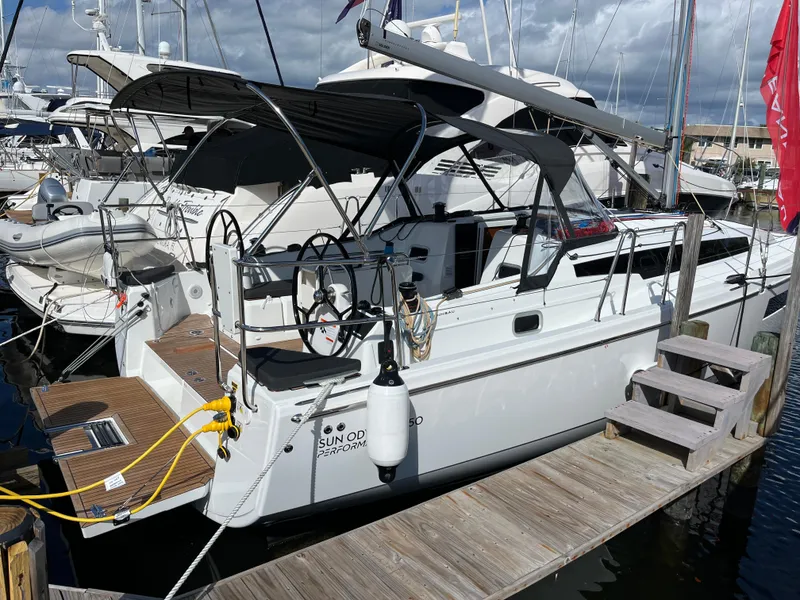 The Image of 2025 Jeanneau Sun Odyssey 350 sailboat docked at marina under cloudy skies. - 0