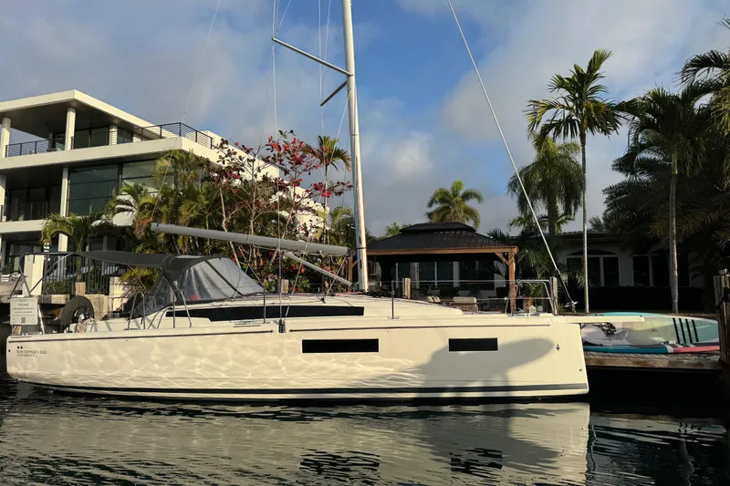 Slide: The Image of 2025 Jeanneau Sun Odyssey 350 sailboat docked near modern waterfront home. - 23