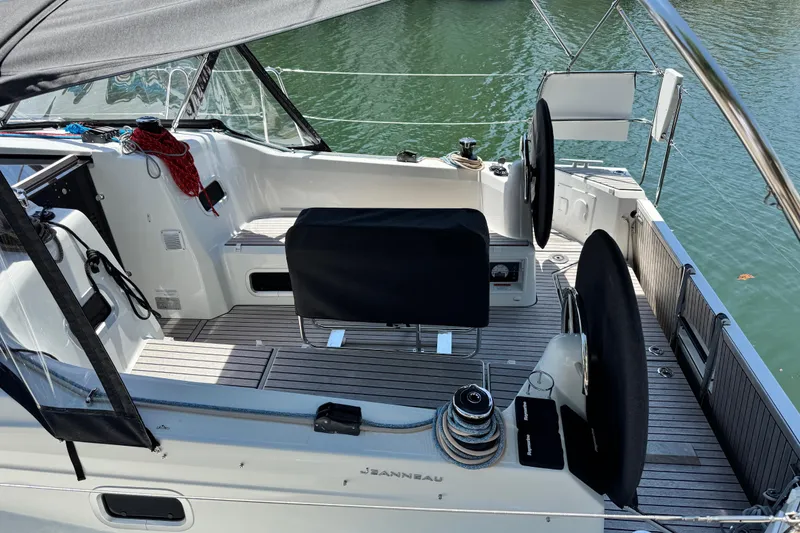Slide: The Image of 2025 Jeanneau Sun Odyssey 350 cockpit with dual steering wheels and sleek design. - 24
