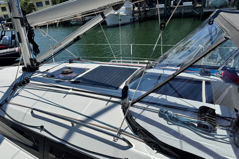 Slide: The Image of 2025 Jeanneau Sun Odyssey 350 sailboat deck with solar panel and marina view. - 26
