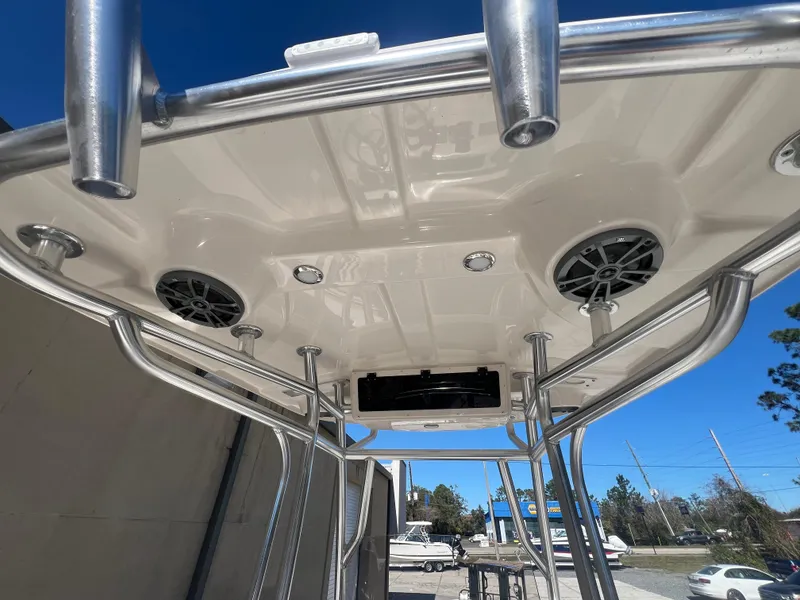 Slide: The Image of 2025 Sea Chaser 22 HFC boat T-top with speakers and lights, clear blue sky background. - 10