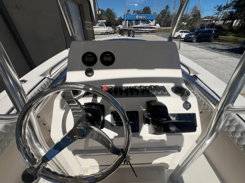 Slide: The Image of 2025 Sea Chaser 22 HFC boat console with steering wheel and controls. - 11