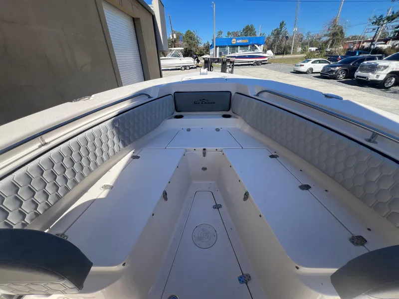 Slide: The Image of 2025 Sea Chaser 22 HFC boat interior with cushioned seating and storage compartments. - 25