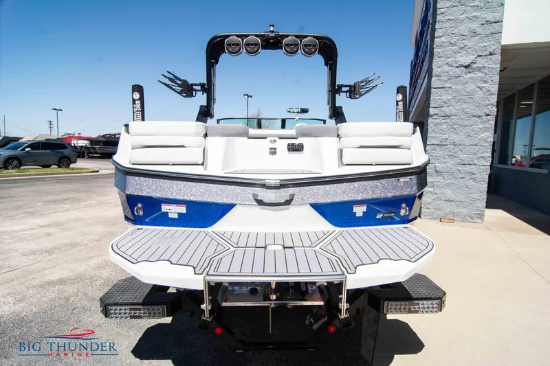 Slide: The Image of 2024 MasterCraft NXT24 boat rear view with swim platform and speakers. - 1