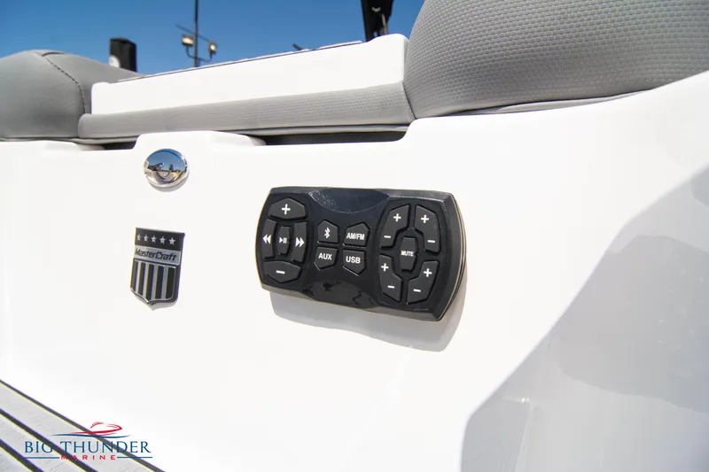 Slide: The Image of 2024 MasterCraft NXT24 boat control panel with audio system buttons. - 14