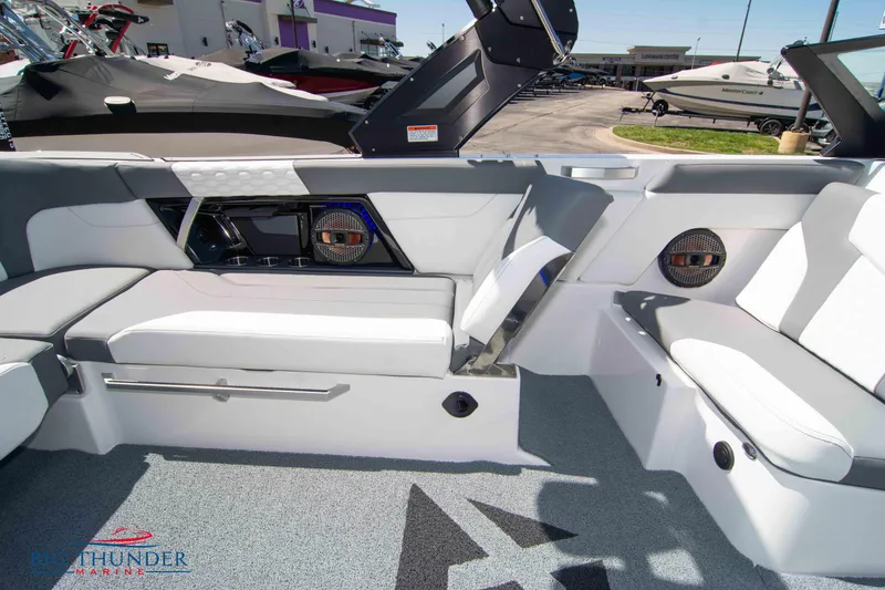 Slide: The Image of 2024 MasterCraft NXT24 boat interior with white seating and modern design. - 22