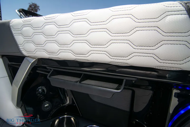 Slide: The Image of 2024 MasterCraft NXT24 interior detail with white hexagonal-patterned upholstery and sleek dashboard design. - 28