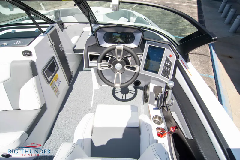 Slide: The Image of 2024 MasterCraft NXT24 boat cockpit with modern steering and control panel. - 31