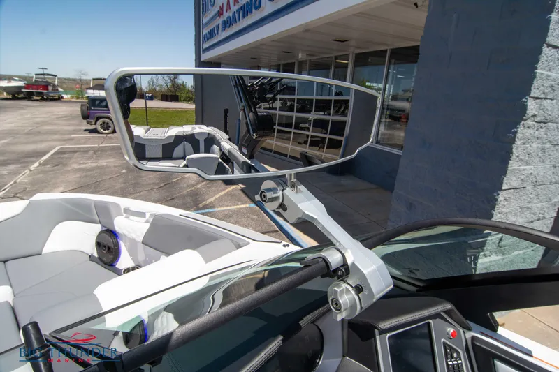Slide: The Image of 2024 MasterCraft NXT24 boat interior with rearview mirror and dashboard. - 38