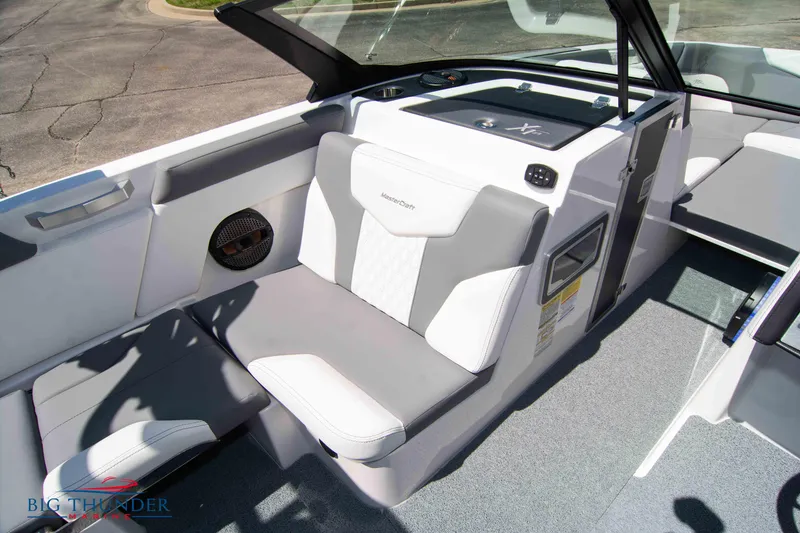 Slide: The Image of 2024 MasterCraft NXT24 boat interior with gray and white seating and modern dashboard. - 43