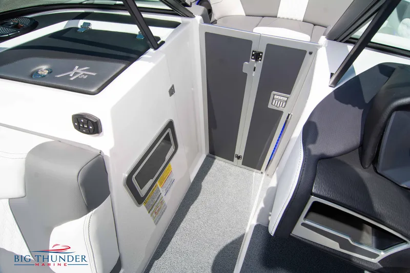 Slide: The Image of 2024 MasterCraft NXT24 boat interior with seating and storage compartments. - 45