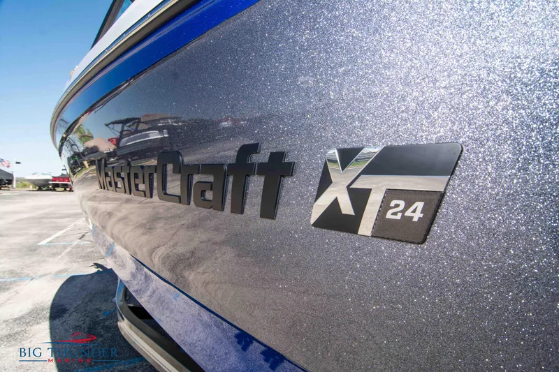Slide: The Image of 2024 MasterCraft NXT24 boat with metallic finish and logo detail. - 7
