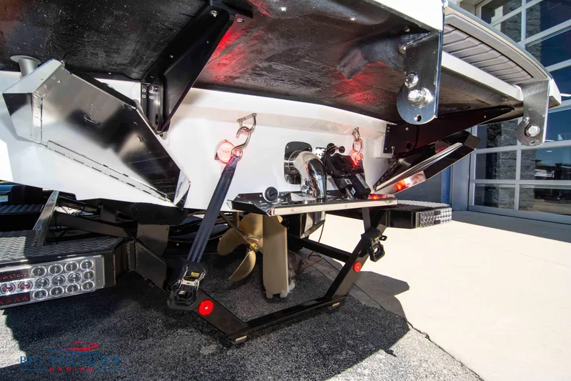 Slide: The Image of 2024 MasterCraft NXT24 boat rear view with propeller and trailer attachments. - 8