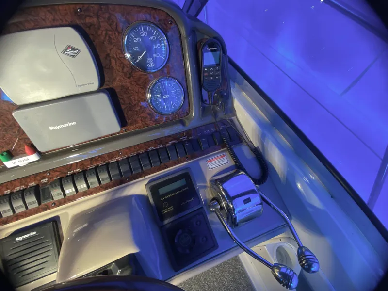 Slide: The Image of Control panel of a 2003 Sea Ray 420 Sundancer with gauges and navigation equipment. - 13
