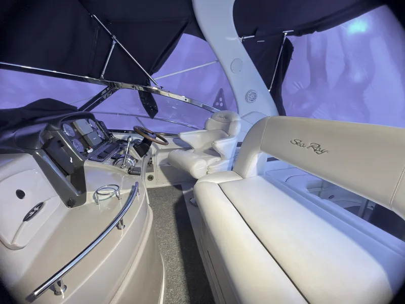 Slide: The Image of Interior of 2003 Sea Ray 420 Sundancer yacht with helm and seating area. - 15