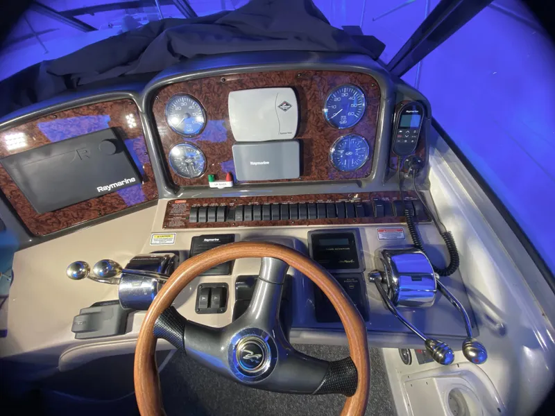 Slide: The Image of 2003 Sea Ray 420 Sundancer dashboard with wood accents and modern navigation controls. - 17