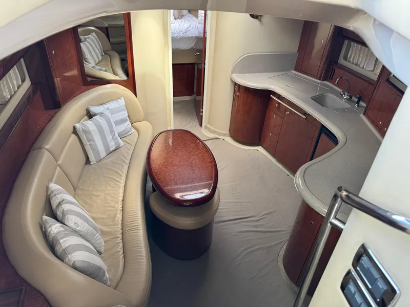 Slide: The Image of Interior of 2003 Sea Ray 420 Sundancer yacht with elegant seating and modern kitchen area. - 19