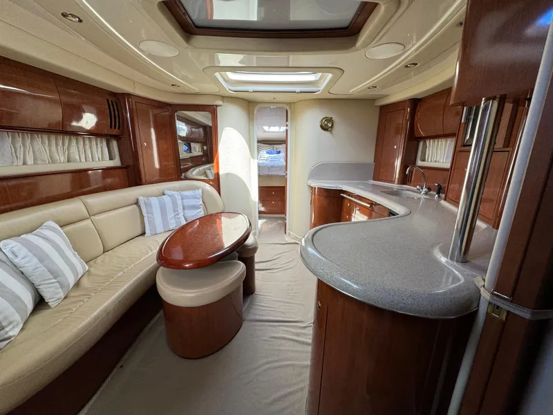 Slide: The Image of Luxurious interior of a 2003 Sea Ray 420 Sundancer yacht with elegant seating and kitchenette. - 20
