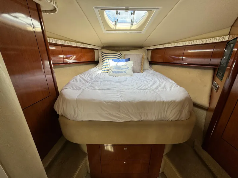 Slide: The Image of Luxurious cabin interior of 2003 Sea Ray 420 Sundancer yacht with cozy bed and skylight. - 28