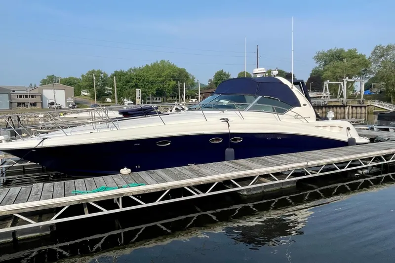 Slide: The Image of 2003 Sea Ray 420 Sundancer yacht docked at marina, side view. - 3