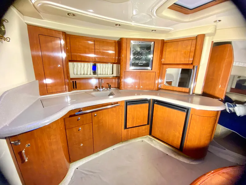 Slide: The Image of Luxurious 2003 Sea Ray 420 Sundancer yacht interior with elegant wooden cabinetry and modern amenities. - 35