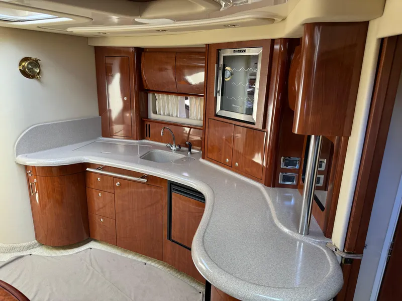 Slide: The Image of Luxurious 2003 Sea Ray 420 Sundancer yacht interior with elegant wood cabinetry and modern amenities. - 36