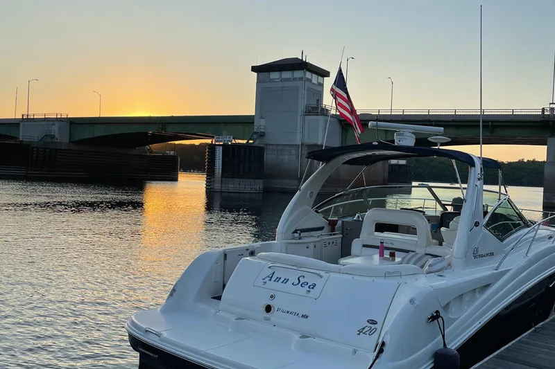 Slide: The Image of 2003 Sea Ray 420 Sundancer yacht docked at sunset near a bridge. - 4