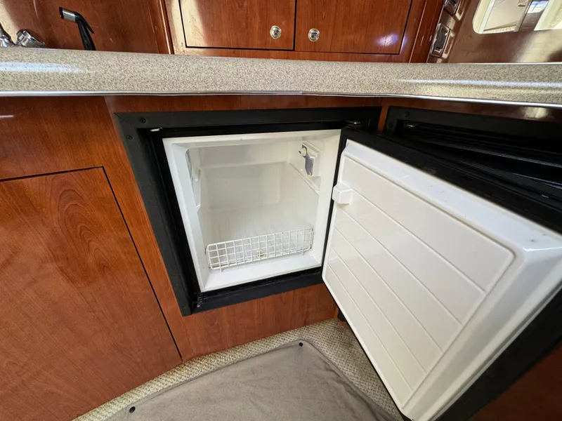 Slide: The Image of Open mini fridge in 2003 Sea Ray 420 Sundancer yacht kitchen area. - 41