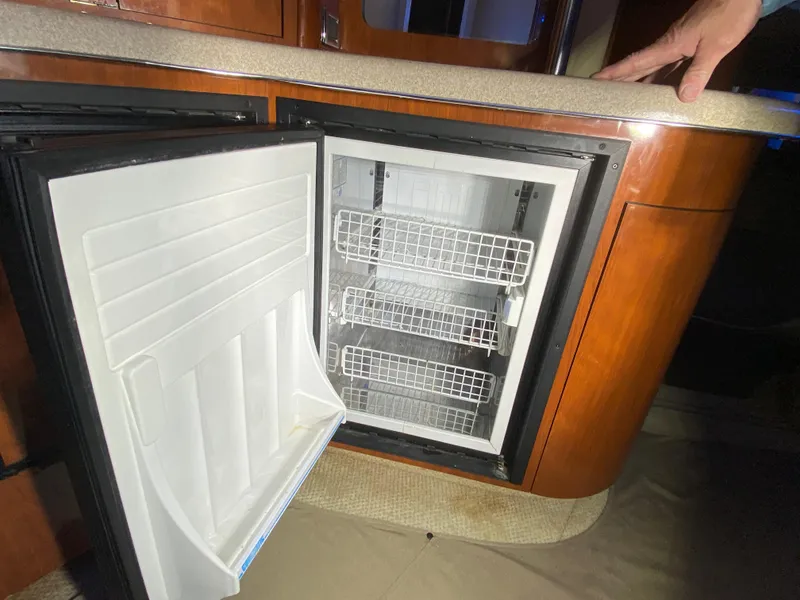 Slide: The Image of Open mini fridge in 2003 Sea Ray 420 Sundancer yacht interior. - 42