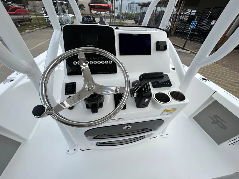Slide: The Image of 2025 Sea Pro 210 Bay boat console with steering wheel and controls. - 17