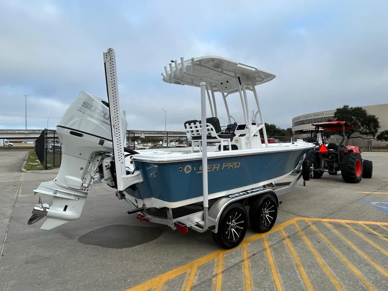 Slide: The Image of 2025 Sea Pro 210 Bay boat on trailer, featuring sleek design and powerful outboard motor. - 4
