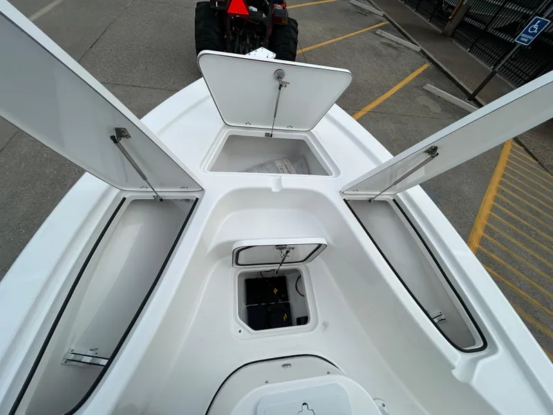 Slide: The Image of 2025 Sea Pro 210 Bay boat with open storage compartments. - 9