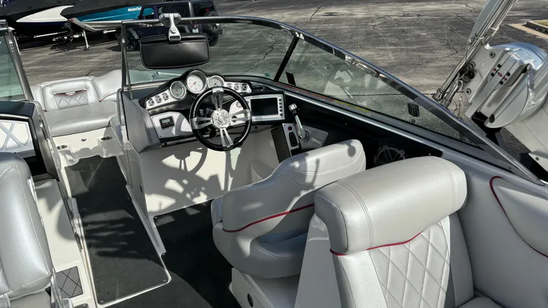 Slide: The Image of 2013 MasterCraft X55 boat interior with modern dashboard and luxurious seating. - 13