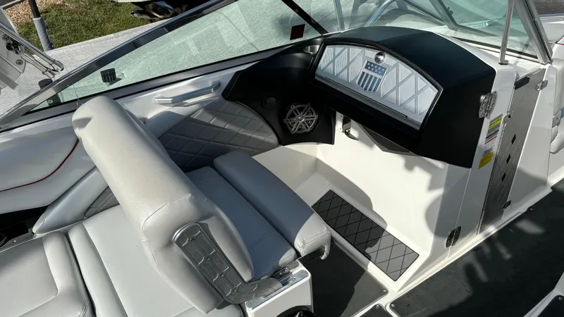 Slide: The Image of 2013 MasterCraft X55 boat interior with sleek dashboard and comfortable seating. - 15