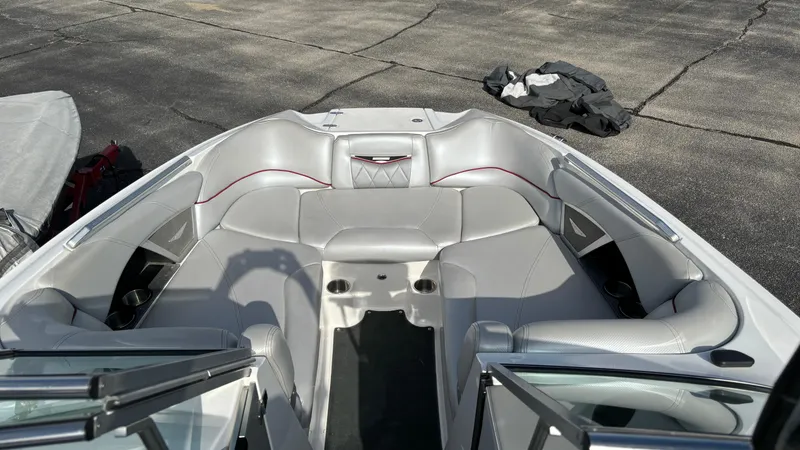 Slide: The Image of 2013 MasterCraft X55 boat interior with gray seating and open bow design. - 17