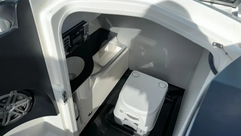 Slide: The Image of 2013 MasterCraft X55 boat interior with compact bathroom amenities. - 21