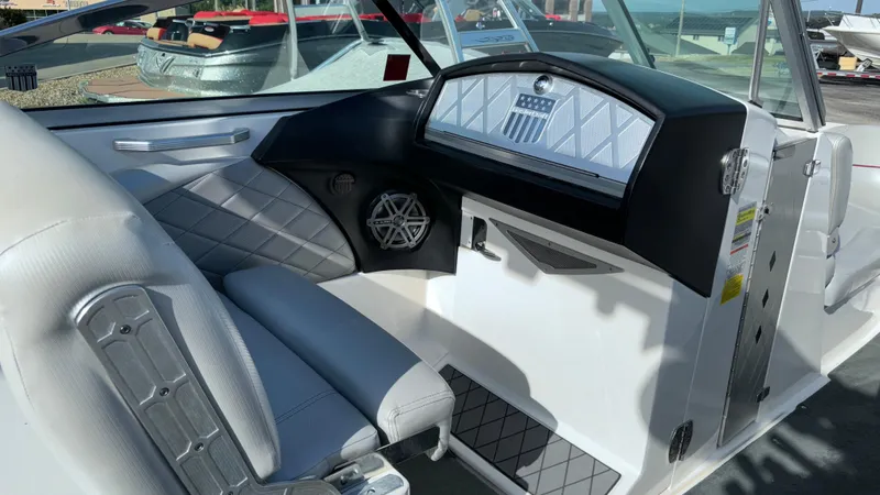 Slide: The Image of 2013 MasterCraft X55 boat interior with sleek white and gray seating. - 24