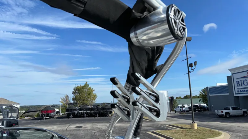 Slide: The Image of 2013 MasterCraft X55 wakeboard tower with speakers and board racks under a clear sky. - 26