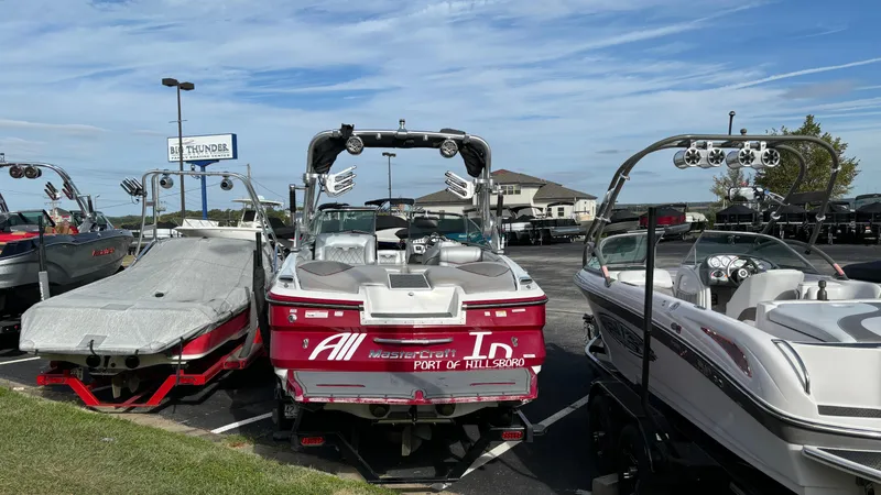 Slide: The Image of 2013 MasterCraft X55 boat in a marina parking lot, surrounded by other boats. - 3