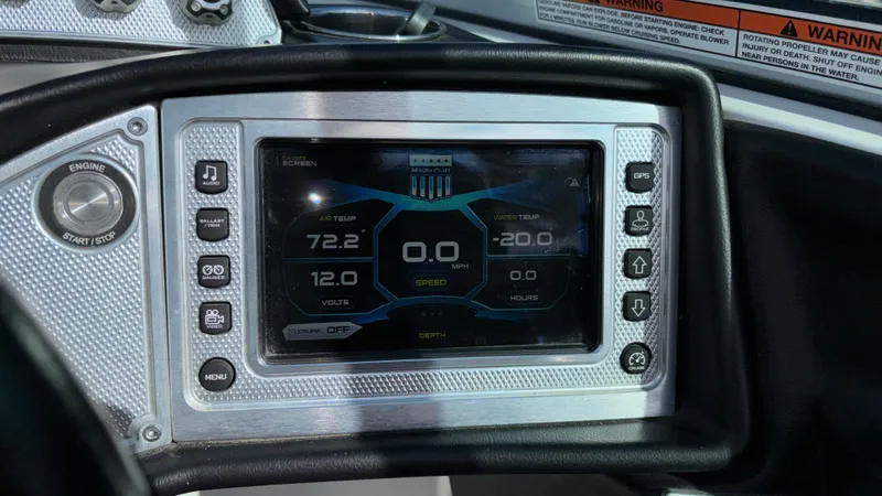 Slide: The Image of 2013 MasterCraft X55 boat dashboard with digital display and control buttons. - 30