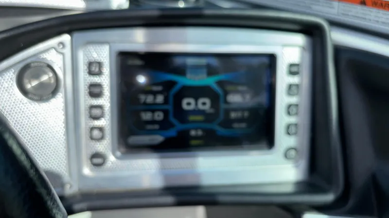 Slide: The Image of Dashboard of a 2013 MasterCraft X55 boat with digital display and controls. - 31