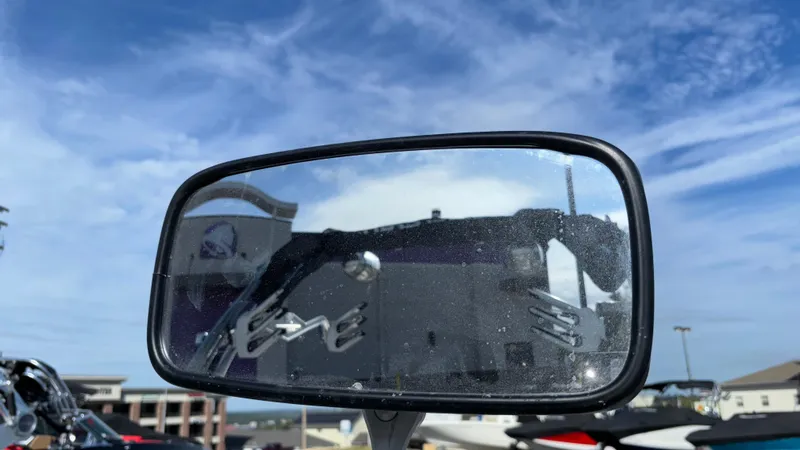 Slide: The Image of Rearview mirror of a 2013 MasterCraft X55 boat reflecting a clear blue sky. - 34