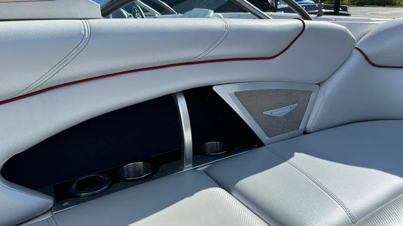 Slide: The Image of 2013 MasterCraft X55 boat interior with sleek white seating and cup holders. - 43
