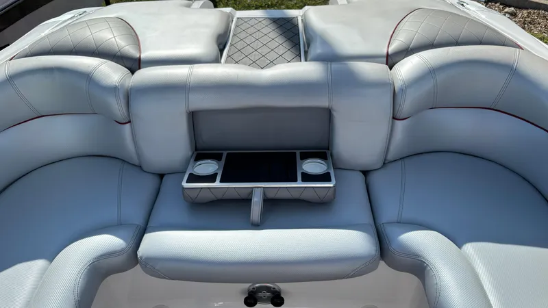 Slide: The Image of 2013 MasterCraft X55 boat interior with gray seating and cup holders. - 44