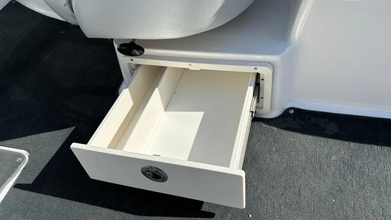 Slide: The Image of Open storage drawer in 2013 MasterCraft X55 boat interior. - 48