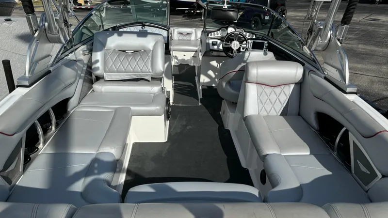 Slide: The Image of 2013 MasterCraft X55 boat interior with luxurious gray seating and modern dashboard. - 8